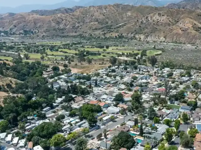 Aerial view of a Sunland neighborhood with the foothills rising behind it